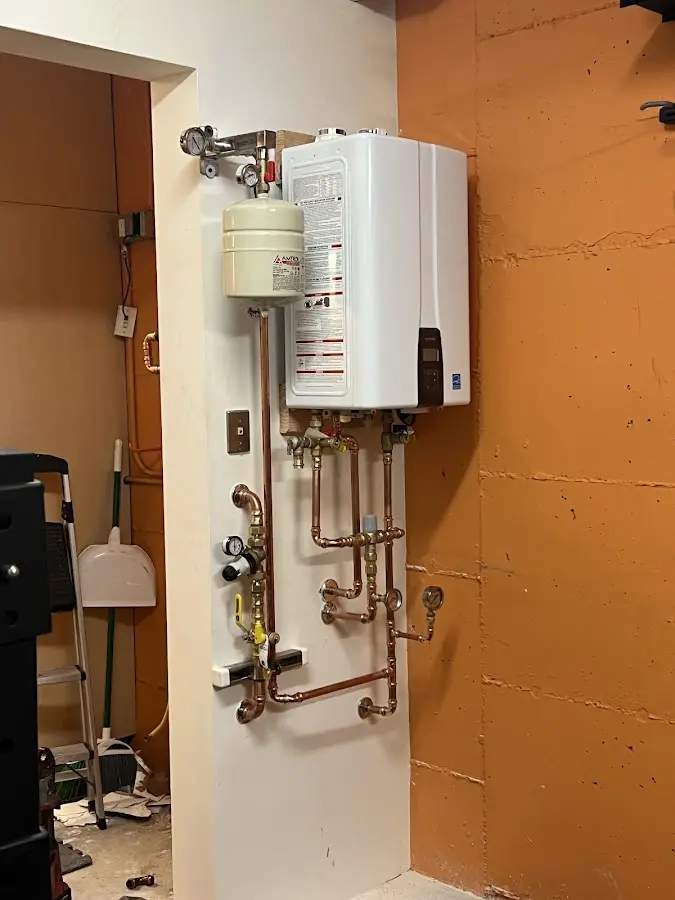 Plumbing technician inspecting water heater connections in Lake Forest